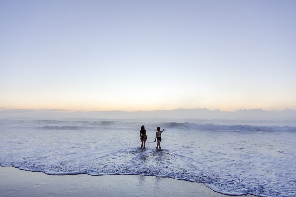 Photo by Lara Wiseman Daniel Photography of attendees on the beach at Wild Spark Retreat 2024